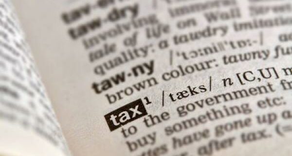 A dictionary opened to the word "tax"